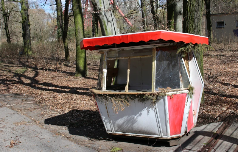 a small outdoor food cart sits by the woods