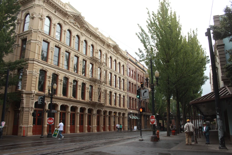 the street is busy with people walking and a traffic light