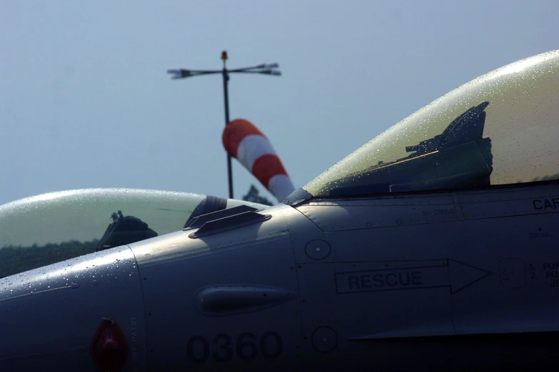 closeup view of two fighter jets on display with flags