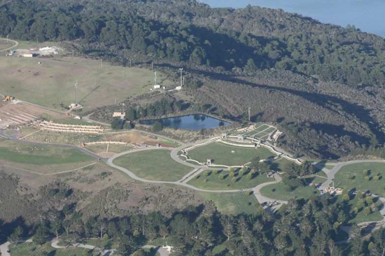 an aerial view of a park and lakes surrounded by forest