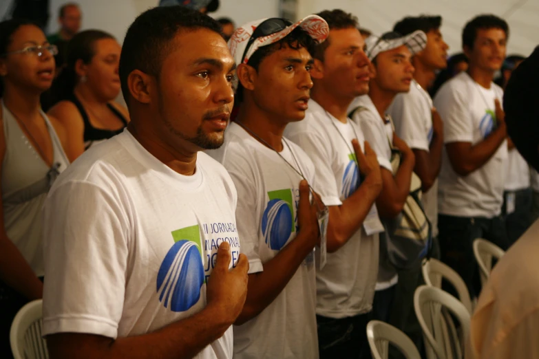 men in white shirts standing in line to perform