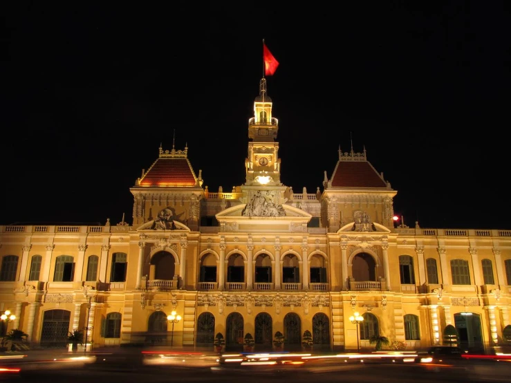 a fancy building lit up for the evening with lights on