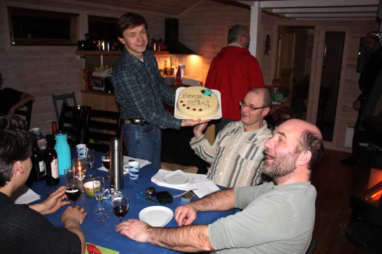 a group of men holding up sandwiches that someone has made