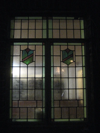 a dark room with two stained glass windows