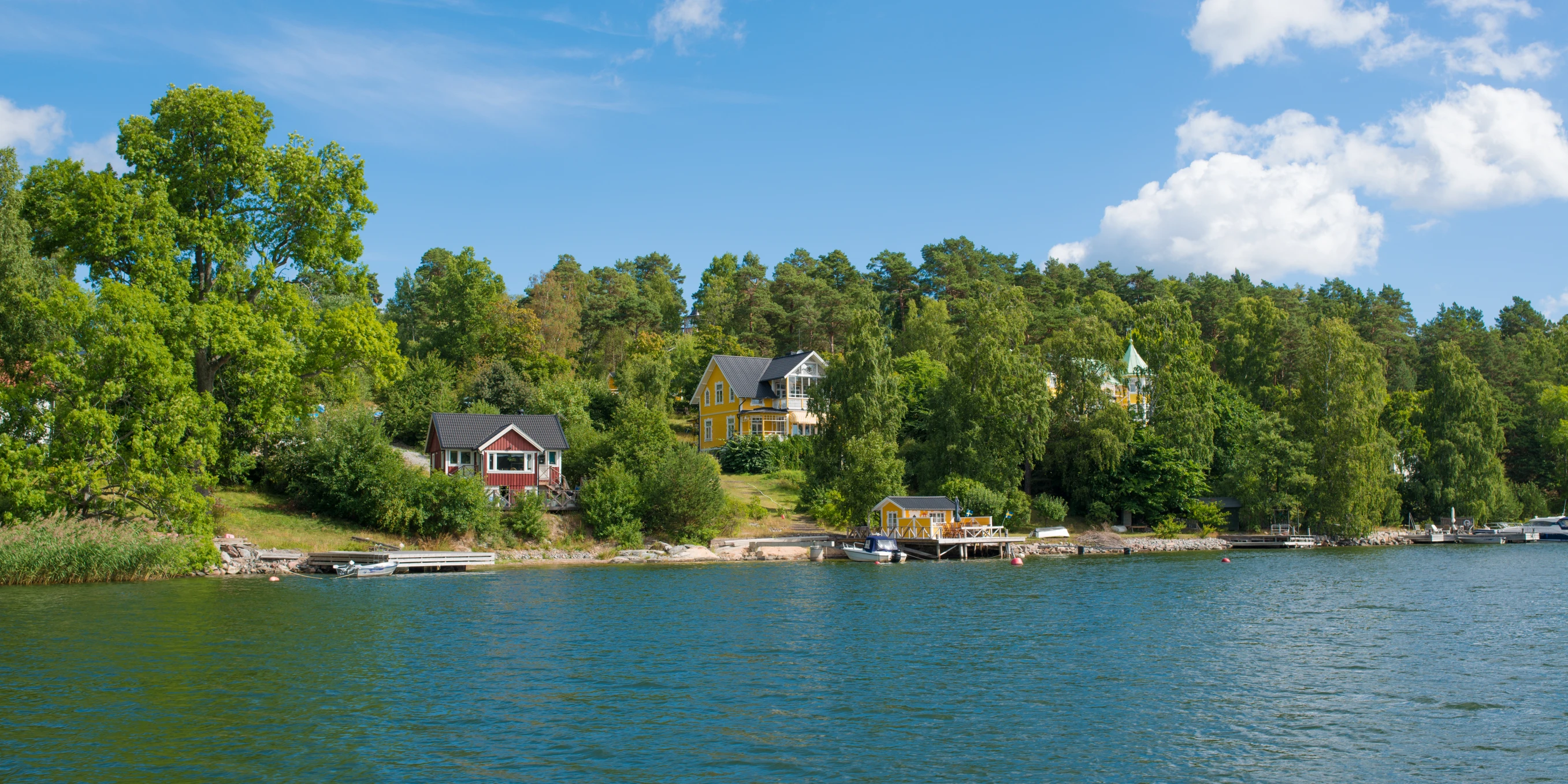 small houses on the bank of a large lake