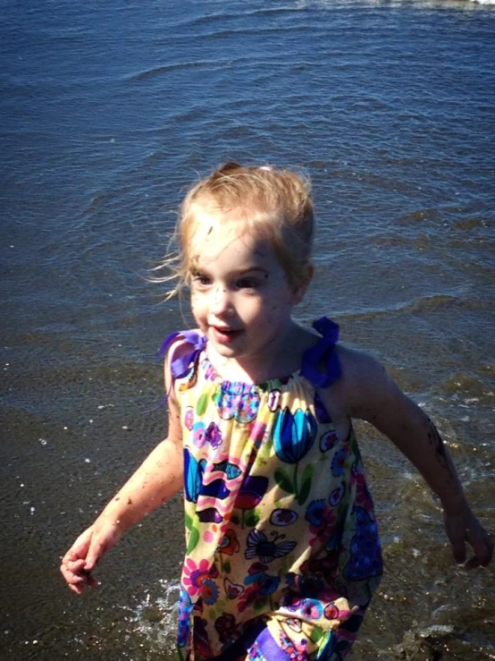 little girl running in the water at the beach
