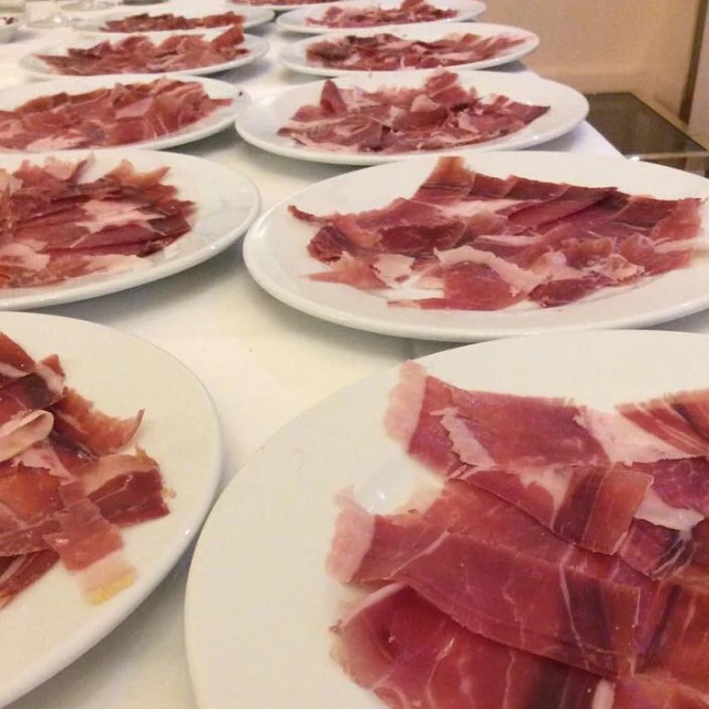 plates filled with bacon sitting on top of a table