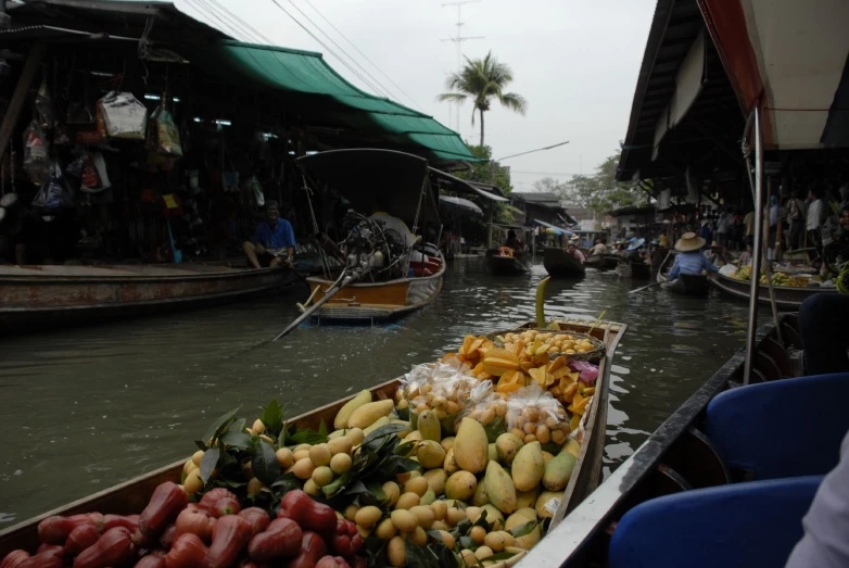 a rowboat filled with lots of different fruits