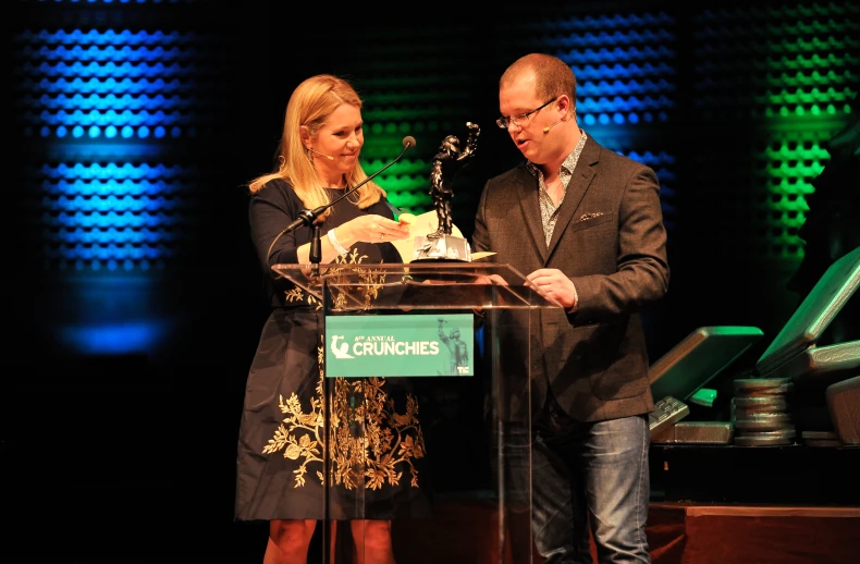 a man and woman at a podium receiving an award