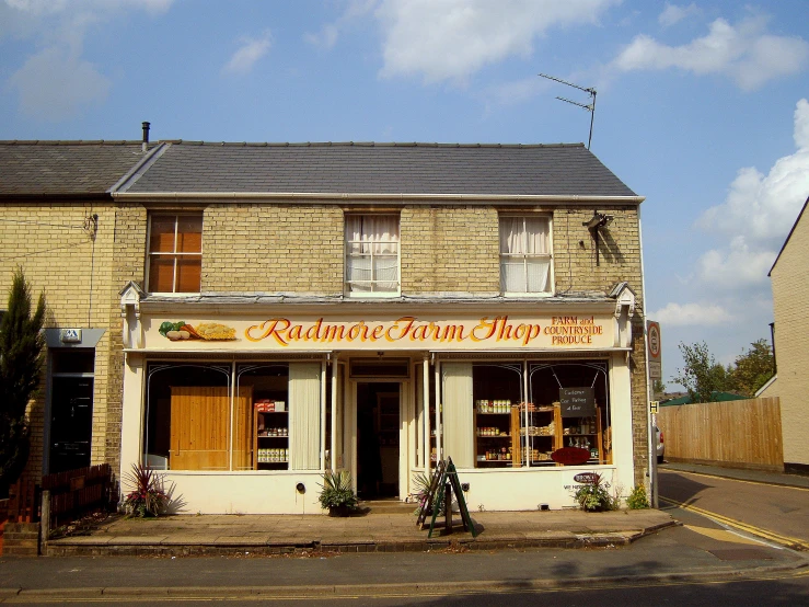 an old stone building with wood trimming and wooden shutters