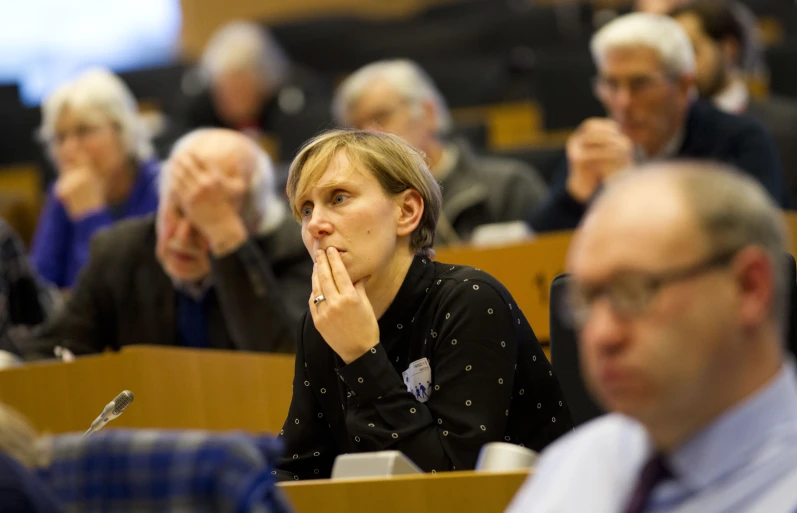 the people sitting in the room are waiting to take part in the lecture