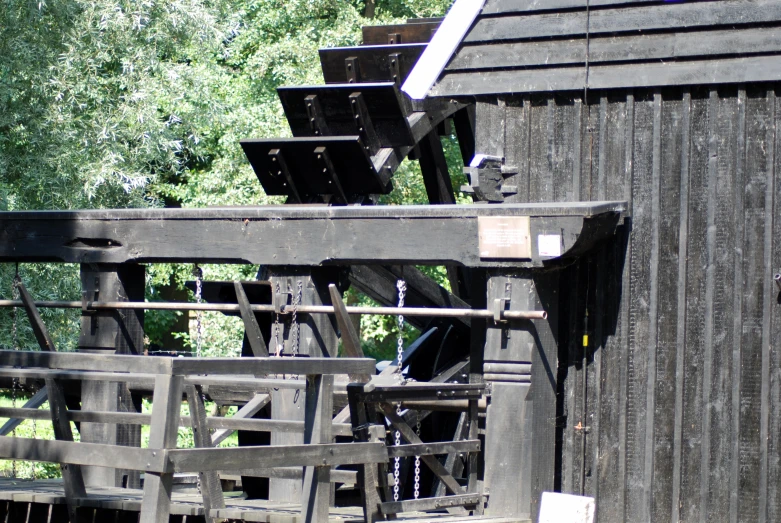 a wooden structure is pictured in front of a wood fence