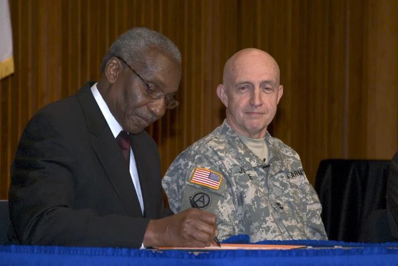 a soldier signing documents for military personnel