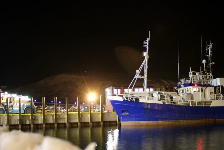 a large boat parked at a dock on the water