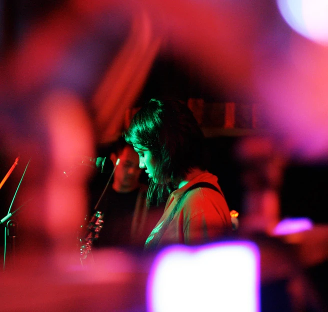 woman at microphone playing music in a band