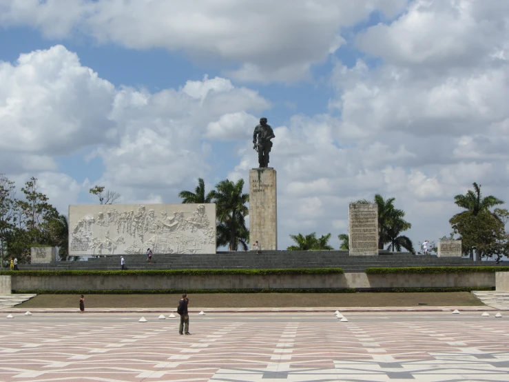 two people are standing outside near a memorial