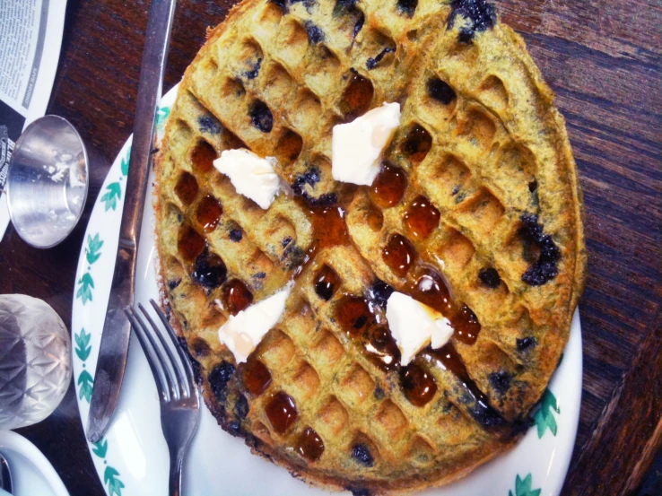 a waffle with syrup and er on a plate