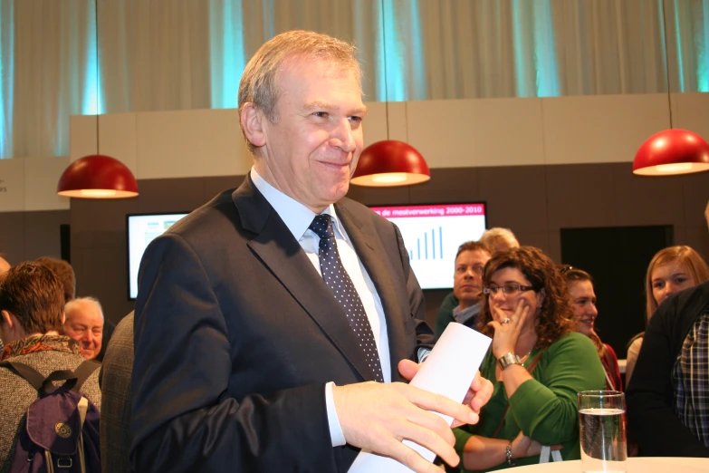 a man in suit and tie holding a video camera