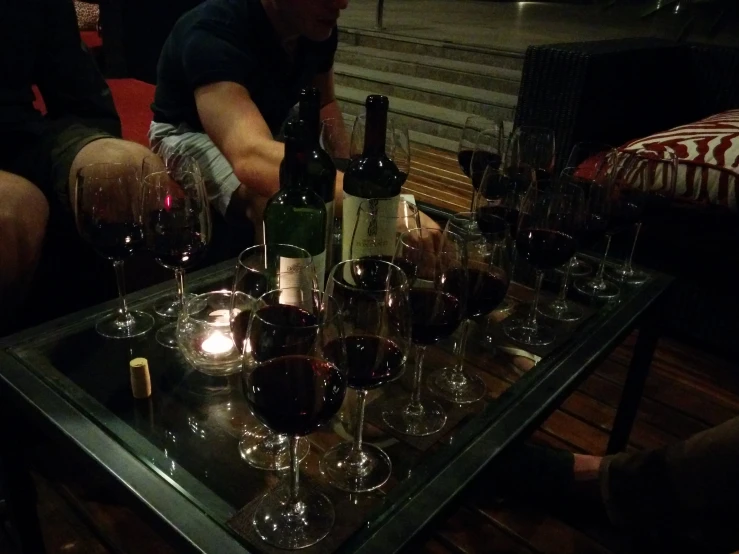 several people sit down to wine for a toast