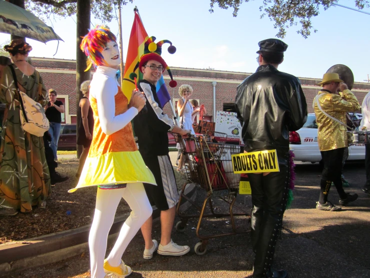 a couple dressed as clowns walking down the street