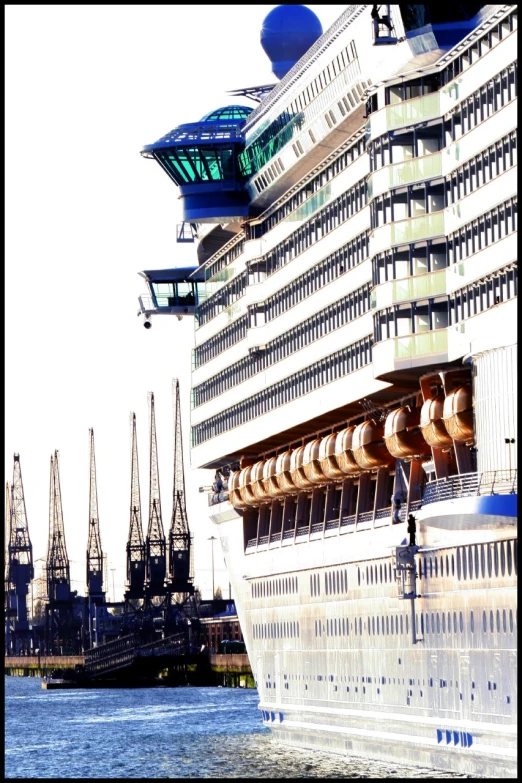 a cruise ship sailing near a harbor filled with tall buildings