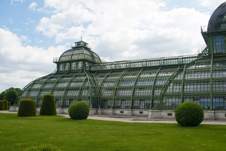 an old style building is made with green leaves