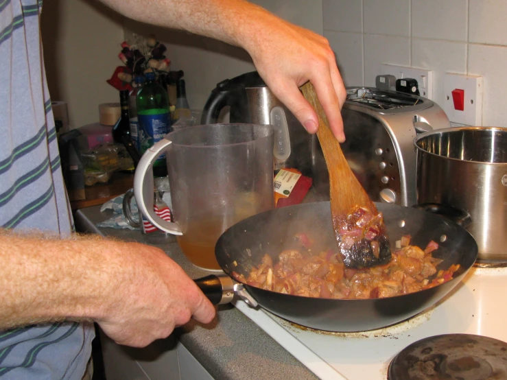 a man is stirring some food in a set