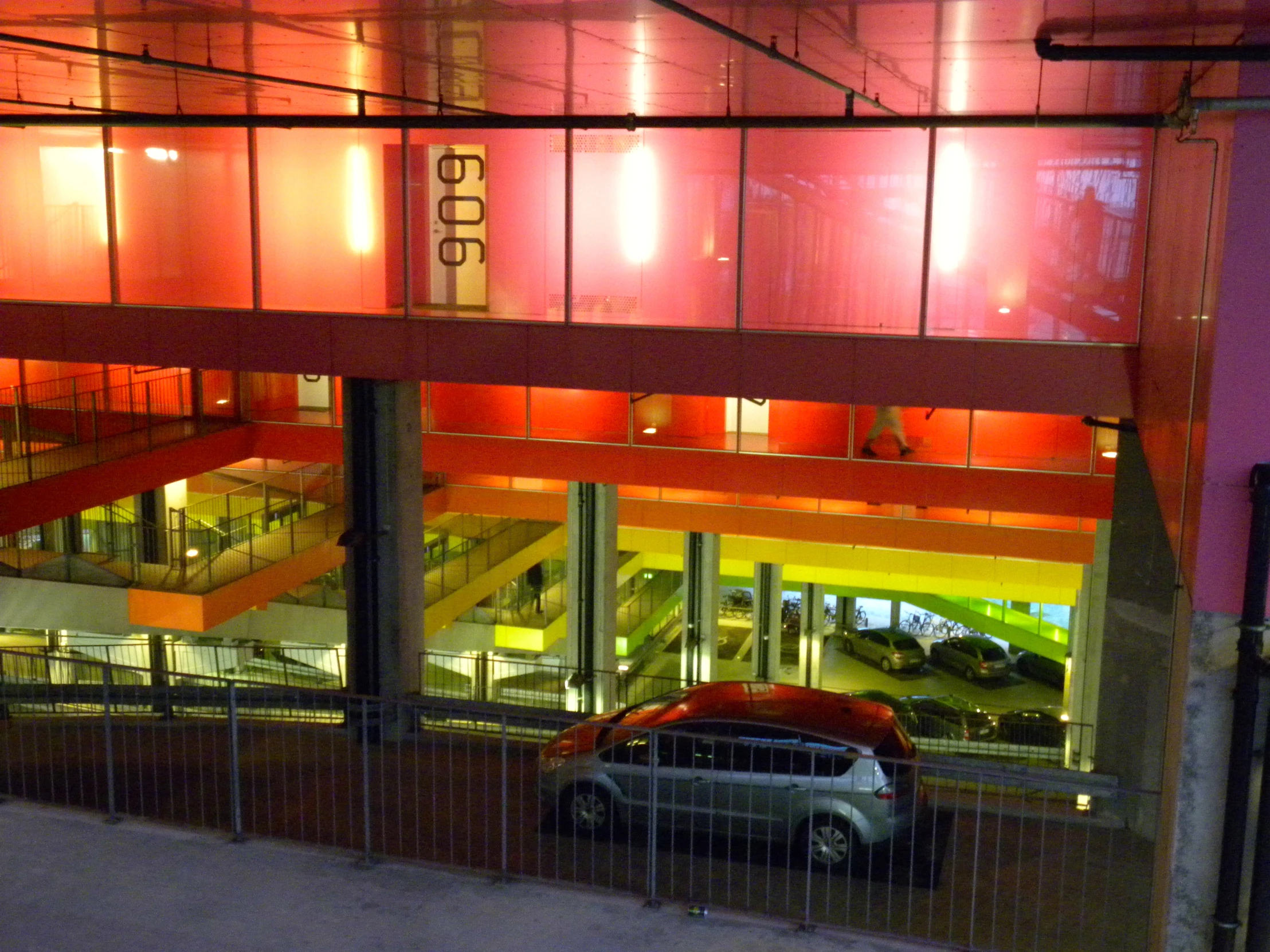 a car parked on the street in front of an entrance with some windows