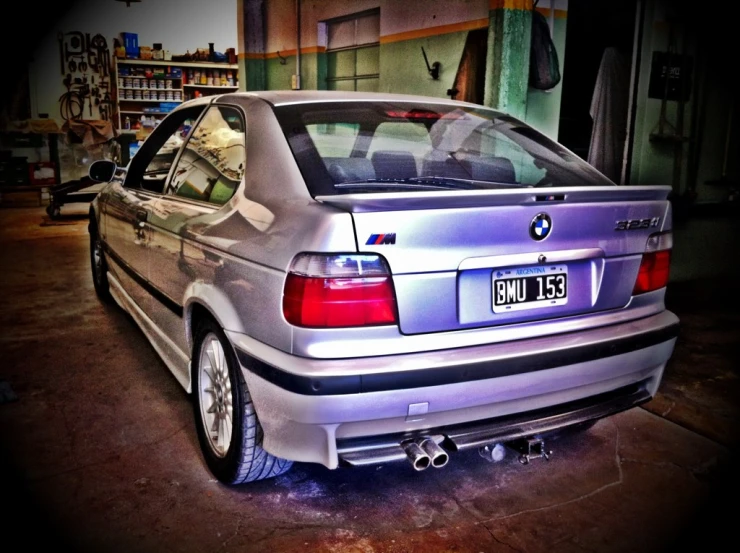 the silver bmw in garage parked at the wheel