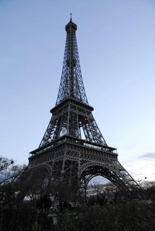 the eiffel tower stands tall as a nice blue sky