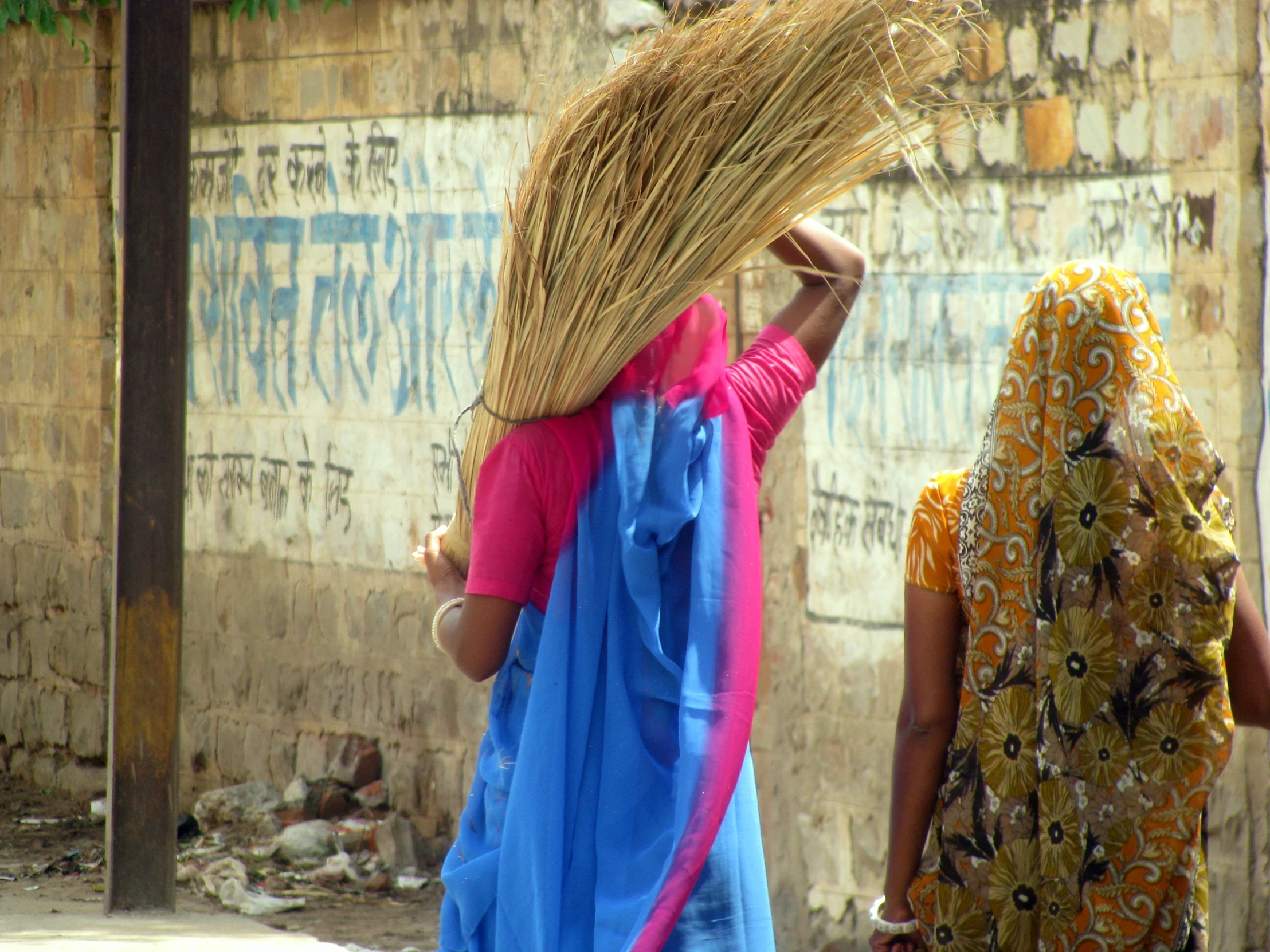 two ladies wearing brightly colored robes are walking together