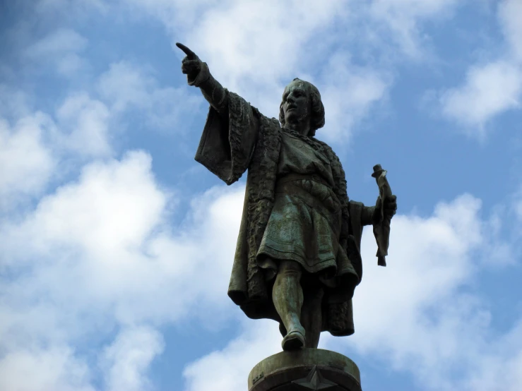 a statue with a hand holding up a bird