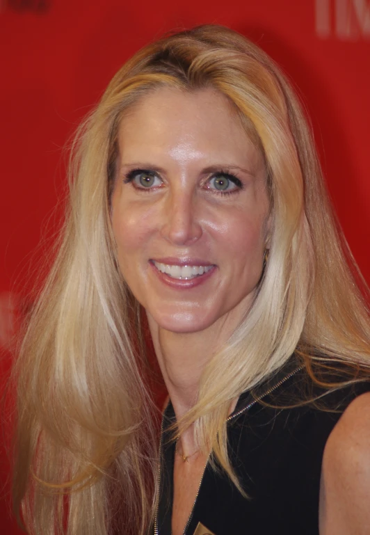 a woman with long hair poses for the camera