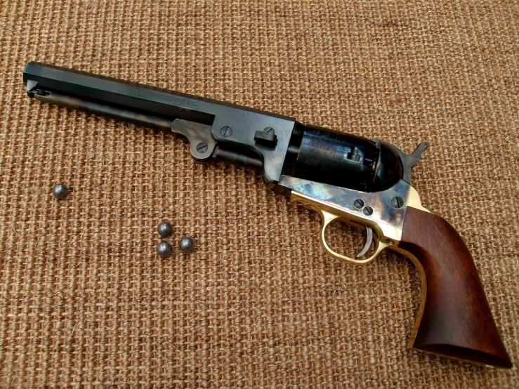a browning pistol with several bullet shells surrounding it