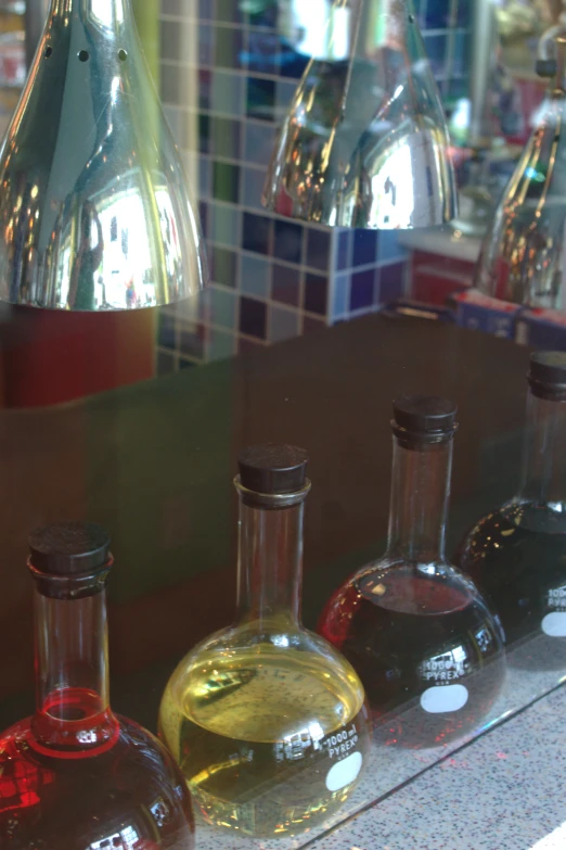 four bottles are lined up on a counter