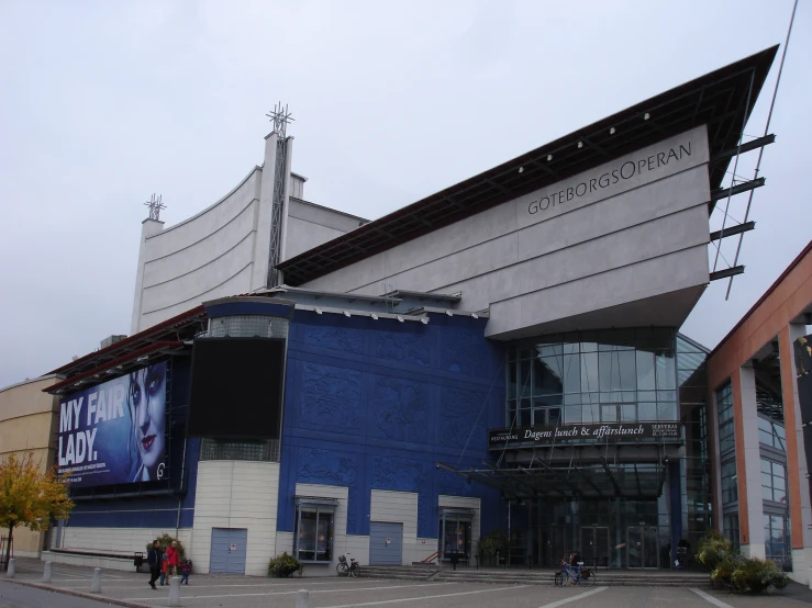 a large blue and white building has a sign on the side of it