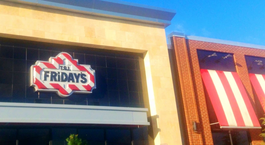 a red and white striped sign on the front of a building