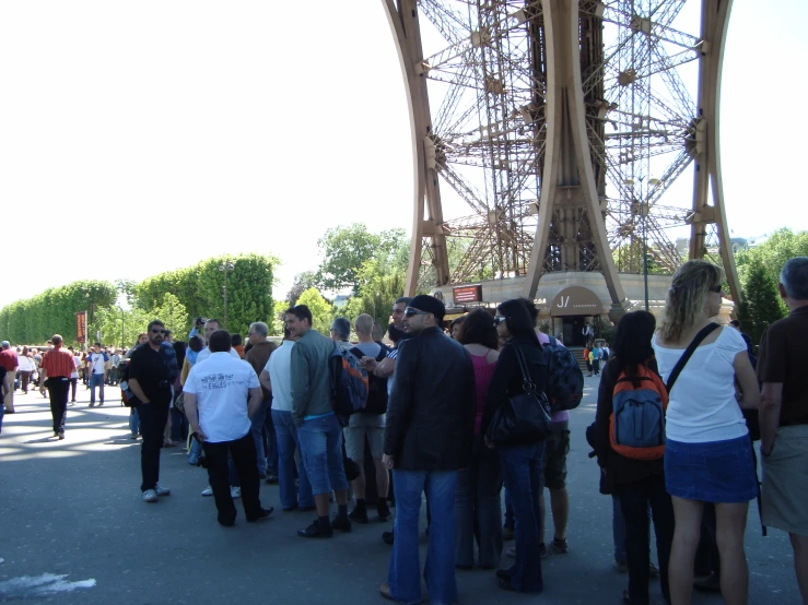 a group of people standing under the eiffel tower