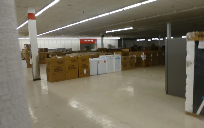 boxes are stacked on the floor inside of an empty building