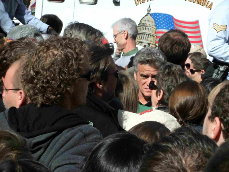 an elderly man is surrounded by a group of people