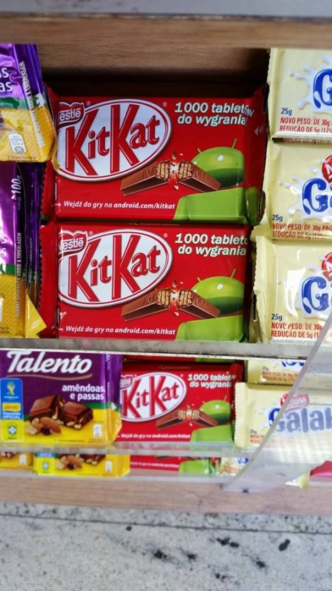 variety of packaged snacks sitting on display in wood case