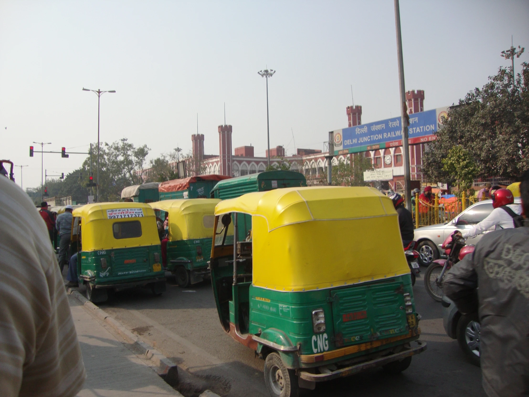 a couple of green and yellow trucks driving down a street