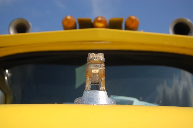 a close up of the rear view mirror of a yellow car