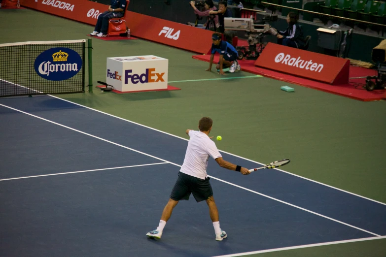 a man swinging a tennis racket on a court