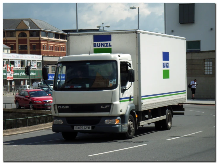 a white box truck going down the road