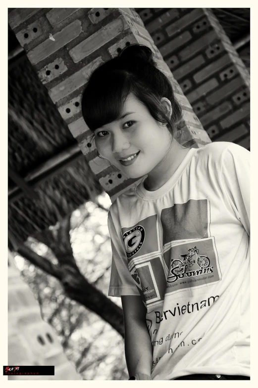an asian girl is posing with her white t - shirt on