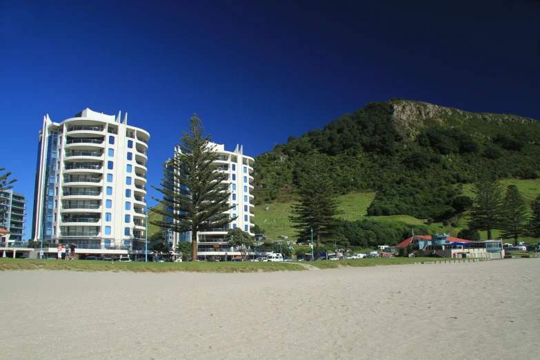 a beach that has some very tall buildings on it