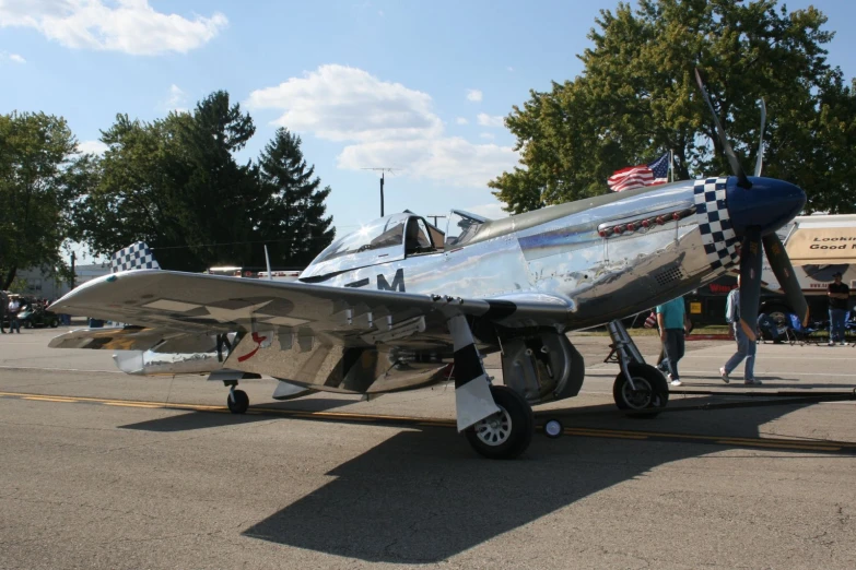 a small airplane with a checkered tail on a runway