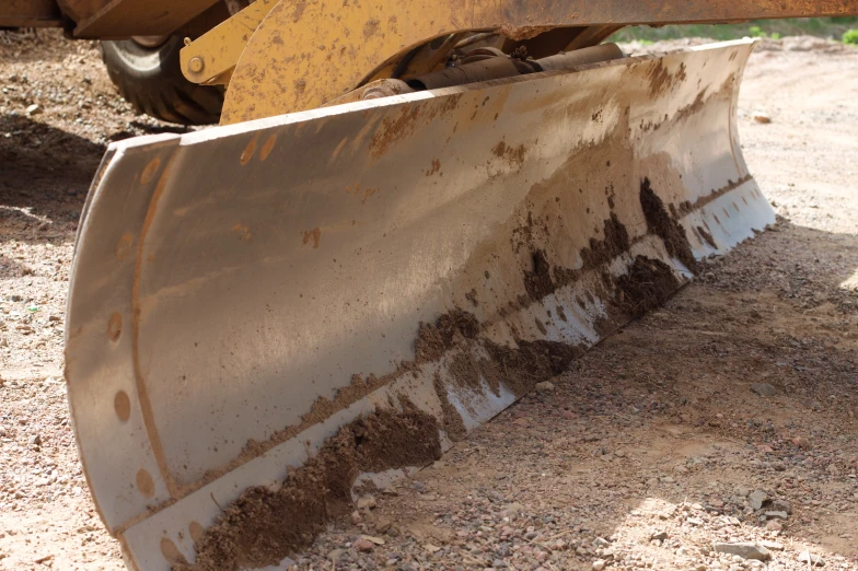 a tractor is sitting in a dirt field