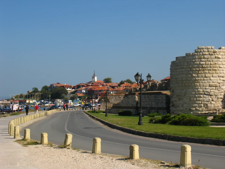 an old city with a clock tower and water street